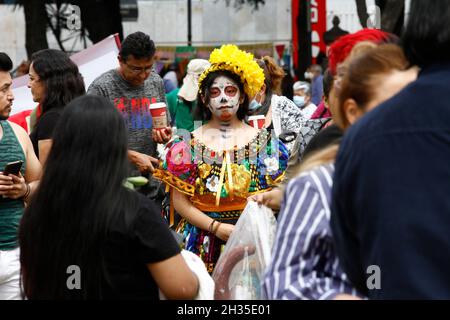 Non Exclusive: A person disguised  as skull at Cempasuchil Flower Fair and decorations at Reforma avenue as part of  the Day of the Dead celebrations. Stock Photo