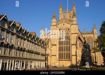 Bath Abbey (church) east front and period buildings glowing orange soon after sunrise in Bath, Somerset, England Stock Photo