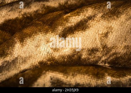Abstract yellow golden creasy velvet fabric background texture Stock Photo