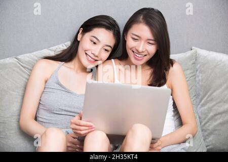Two best friends using a computer together Stock Photo