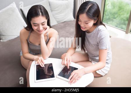 Two best friends using a laptop computer together Stock Photo