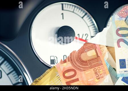 Fuel gauge in a car and euro banknotes Stock Photo