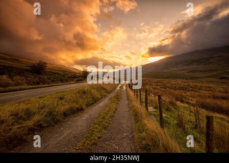 Sunrise on the A4086 between Capel Curig and Pen-y-Pass in Snowdonia National Park, Wales UK Stock Photo