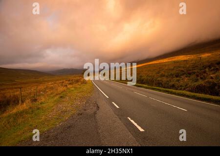 Sunrise on the A4086 between Capel Curig and Pen-y-Pass in Snowdonia National Park, Wales UK Stock Photo