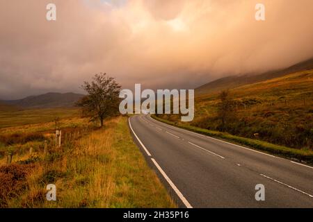 Sunrise on the A4086 between Capel Curig and Pen-y-Pass in Snowdonia National Park, Wales UK Stock Photo