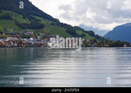 Residential buildings located on the slope of the hill on the edge of Lake Lucerne are visible at a distance. The Lake of the four Cantons. Stock Photo