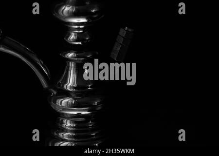 Hookah shaft close-up on a black background. Black and white photo.  Stock Photo