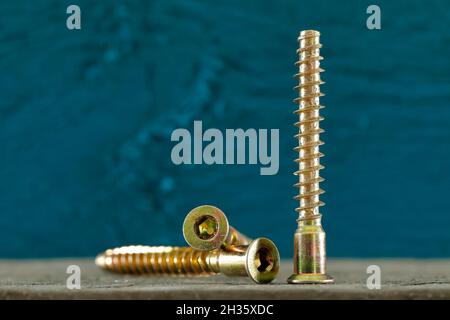 These are three special-purpose screws that have been shown on a dark colored background. Stock Photo