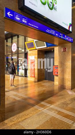 man looking at arrivals and departure boards, Geneva-Cornavin railway station Stock Photo