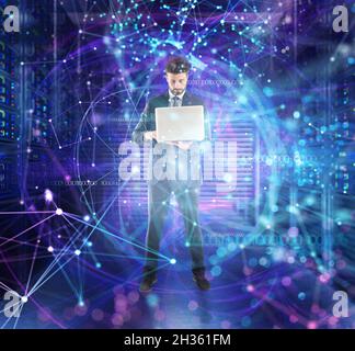 Businessman works at a data center with database servers in a dark background Stock Photo
