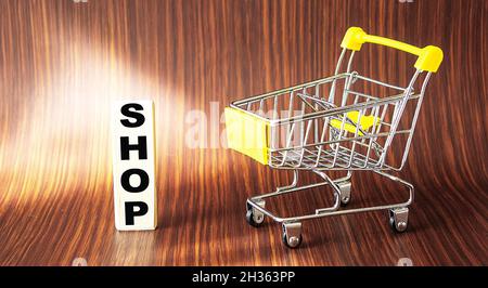 Shop, the word is written on a wooden block, next to a food cart. Wooden table for your design, concept. Stock Photo