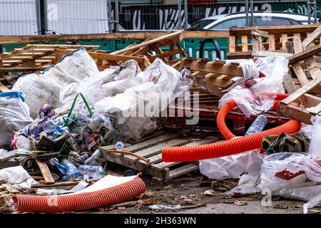 Pile of Waste Building Material Including Wooden storage Pallets Plastic Sheeting And Pipes Stacked Wiating for Collection With No People Stock Photo