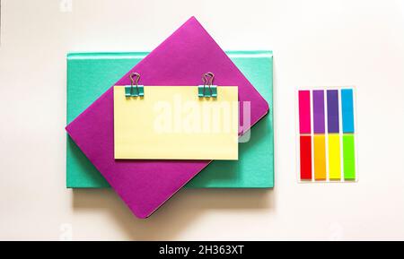 Two multi-colored notebook and color stickers on a white background. Place for inscription, text on sticker. Stock Photo
