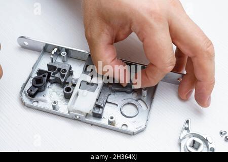 door lock inside. the lock was disassembled to detect a breakdown. broken magnetic latch Stock Photo