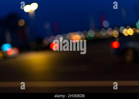 Bokeh effect from street lights and car at night. Stock Photo