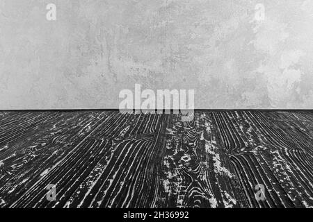 Empty black wooden surface against gray decorative plaster or concrete background. Mockup for design. Stock Photo