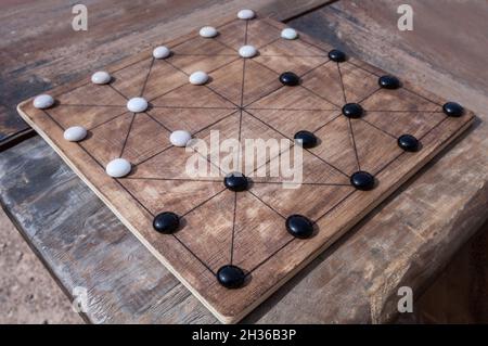 Alquerque, also known as Qirkat. Strategy board game originated in the Middle East Stock Photo