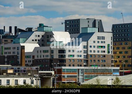 Regenerated & developed area of city (modern high-rise student apartments) contrasting with older disused building - Leeds, Yorkshire, England, UK. Stock Photo