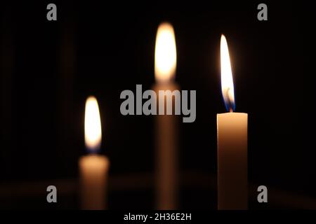 Candles burning in a dark room. Burning candles. Stock Photo