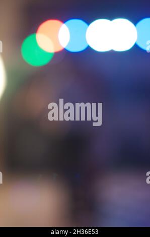 Vertical, dark blurred background with some bokeh light on the top Stock Photo