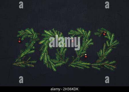 Numbers 2022 made from fir branches. Dark background. New Year or Christmas background. Stock Photo