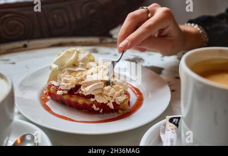 A girl eats dessert in a coffee shop Stock Photo