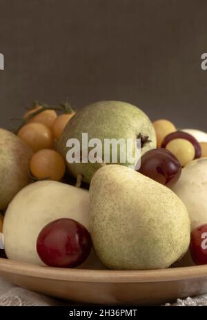 Still life: fruit in a ceramic plate Stock Photo