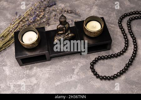 Statue of Buddha. Sculpture of buddha and a burning candle. Stock Photo