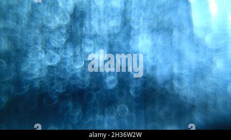Rain in blue color bokeh abstract photo Stock Photo