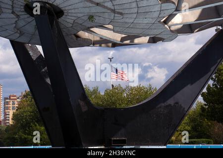 An American flag as seen through the Unisphere in Flushing Meadows Corona Park in Queens, New York City. Stock Photo