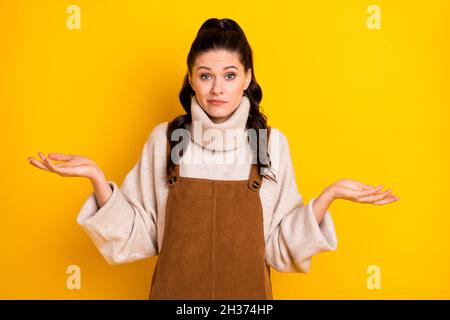 Photo of nice brunette unsure curly hairdo lady shrug shrimps wear sweater isolated on yellow color background Stock Photo
