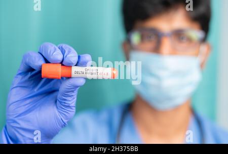 Doctor or nurce showing Blood sample of new Coronavirus or covid varient AY.4.2 - cocnept of covid-19 delta plus mutation. Stock Photo