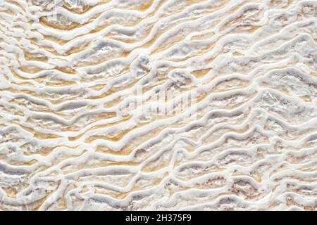 Textural background of asymmetric drawing. Natural texture of travertine Pamukkale. Close-up Stock Photo