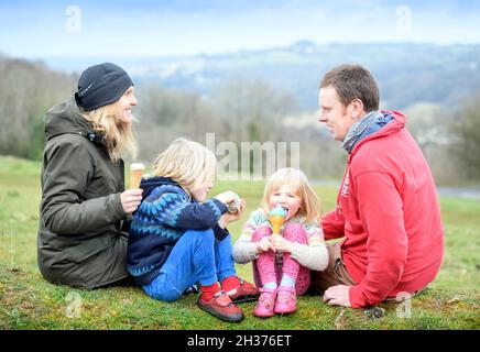 A family with ice creams from Winstones Ice Cream on Rodborough Common in Stroud, Gloucestershire. Stock Photo