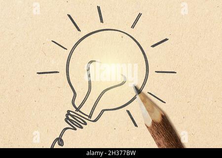 Hand drawn light bulb with wooden pencil on recyled paper background - Concept of creative idea and ecology Stock Photo