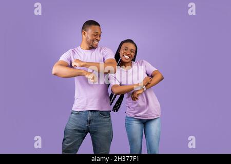 Portrait of cheerful positive black couple dancing at studio Stock Photo