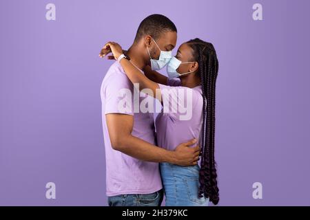 African American couple kissing in face masks Stock Photo