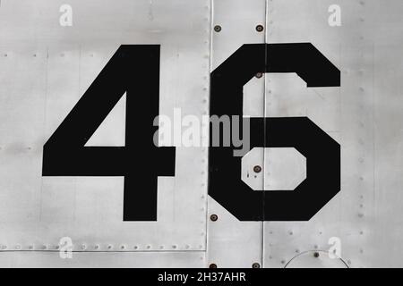 Number 46 on the side of the silver metallic fuselage of an aircraft Stock Photo