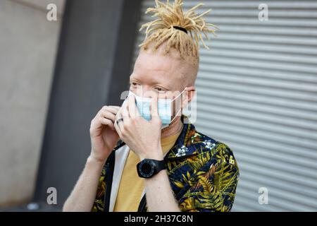 Albino african american man with dreadlocks wearing face mask Stock Photo