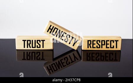Wooden blocks with the words TRUST, HONESTY, RESPECT, on a white and black background. Stock Photo
