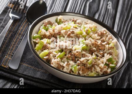 Dirty rice is New Orleans staple and a simple dish combining beef and minced chicken liver along with peppers and onions close-up in a plate on the ta Stock Photo