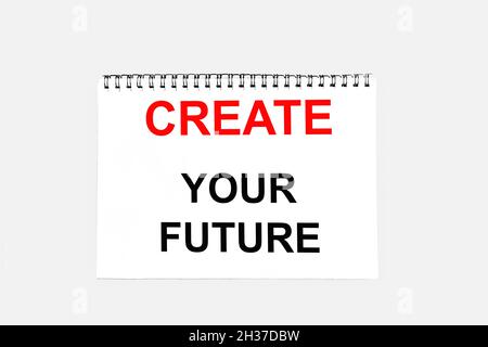 Create your future, text is written on white sticky note and gray background. Stock Photo