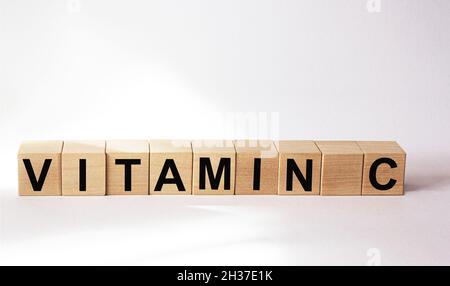 Wooden blocks with the text: Vitamin C on a white background Stock Photo