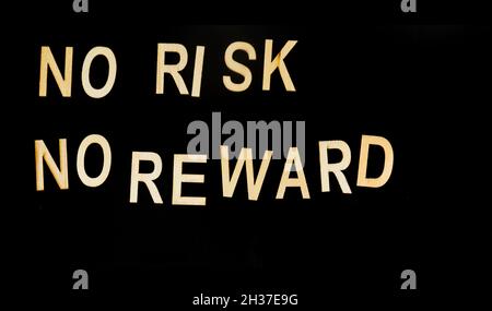 On a black background, wooden letters with the text: No risk, no reward Stock Photo