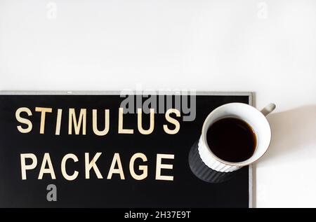 Incentive Package the word is written in wooden letters in a vintage look, next to coffee on a mirrored black background Stock Photo
