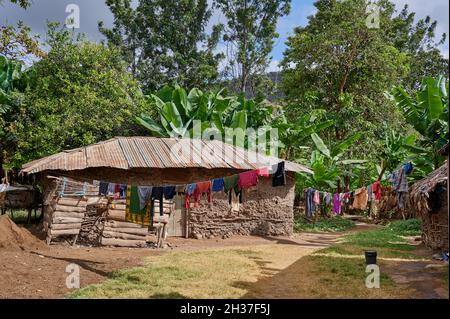 clay huts and laundery during village walk in Mto wa Mbu, Tanzania, Africa Stock Photo