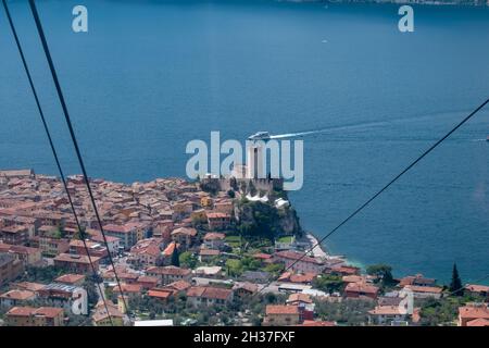 View of the Castello Scaligero di Malcesine from the cable leaving Malcesine on the way to the summit of Monte Baldo Stock Photo