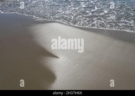 sandy beach and sea foam on the Mediterranean cosat travel destination Spain Stock Photo