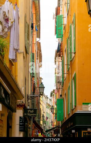 Nice, France - July 16, 2018: old colorful buildings in a narrow street of the old town of Nice Stock Photo