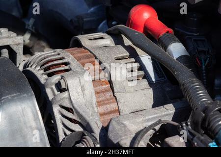 Alternator. Details of a flat-four (boxer) car engine compartment under the open hood. Closeup side view Stock Photo